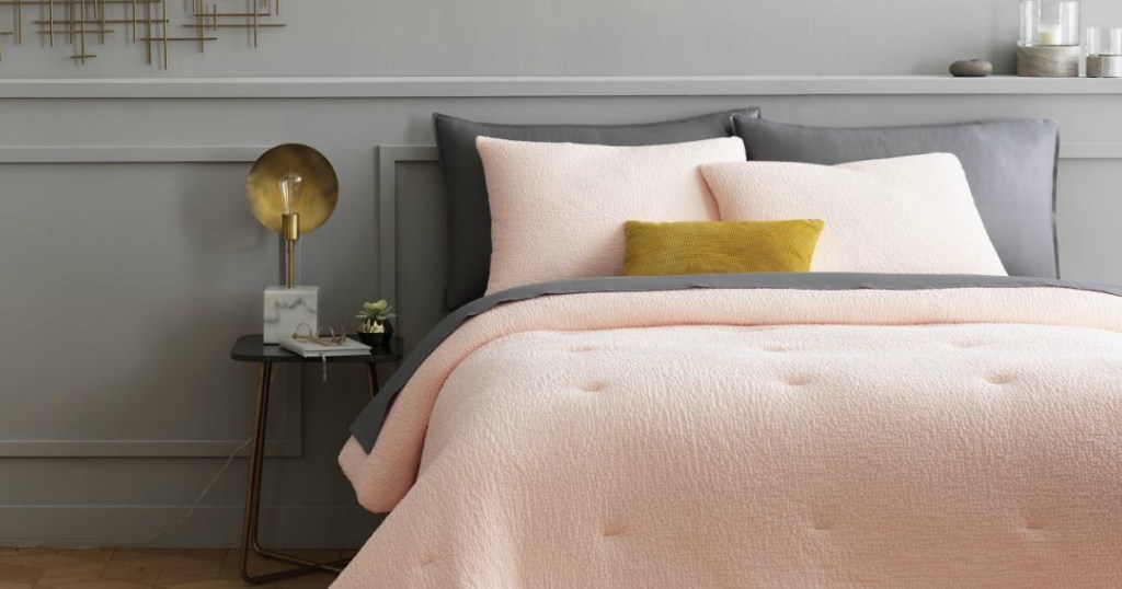 Light pink comforter and shams with dark gray sheets