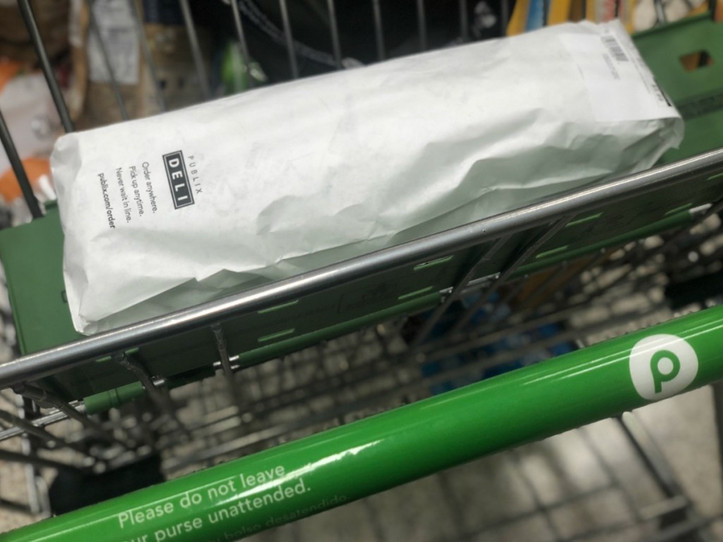 Publix sub wrapped up and sitting in a Publix shopping cart