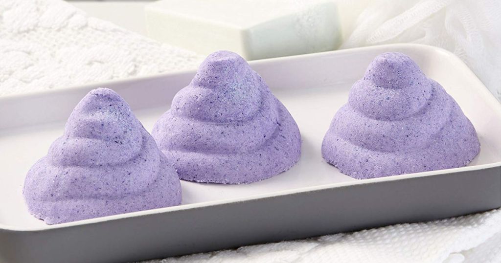 Purple poop shaped soap on tray in the bathroom