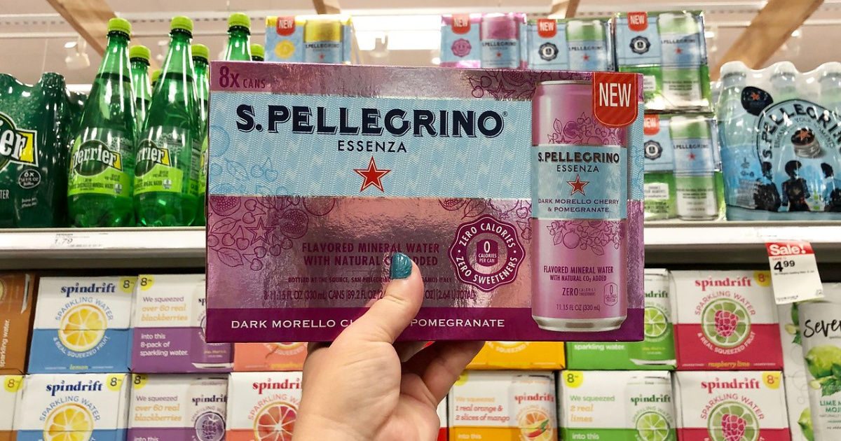 hand holding a case of san pellegrino in front of a Target shelf