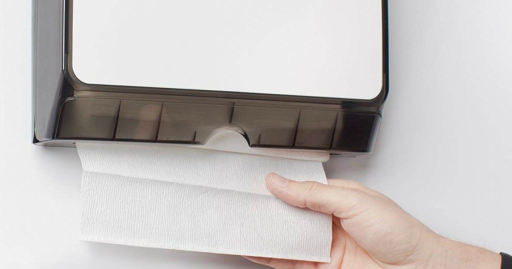 hand grabbing paper towel from dispenser