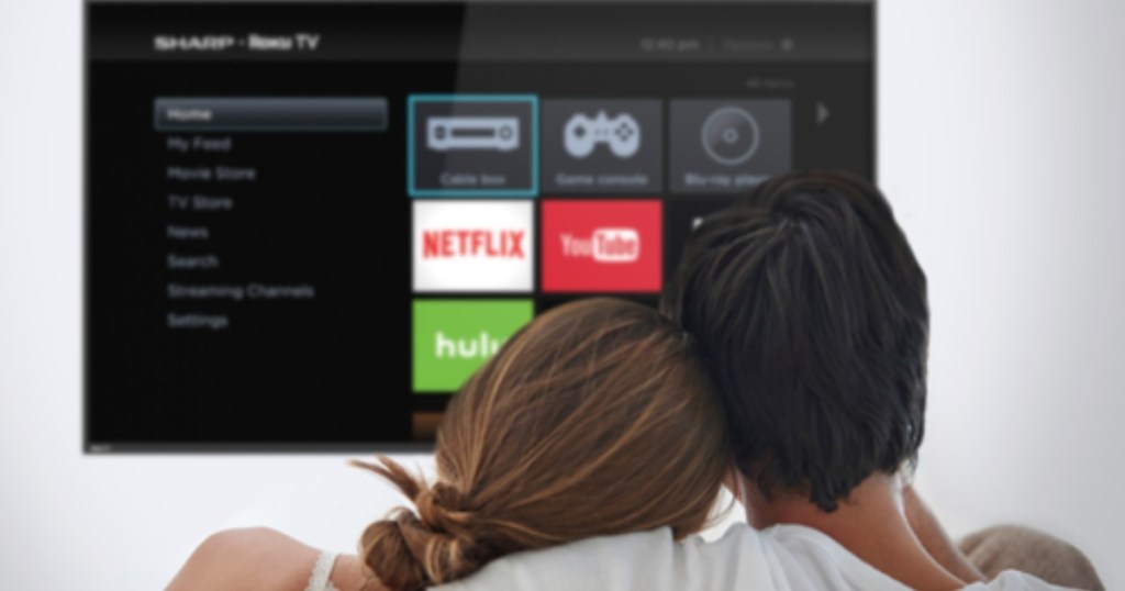 Man and woman sitting in front of a smart TV