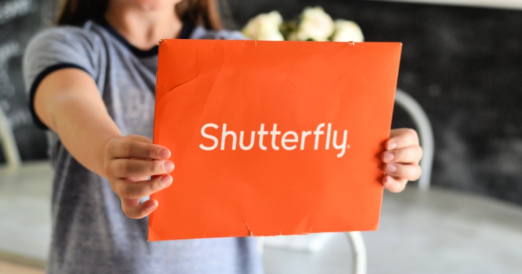 girl holding shutterfly envelope