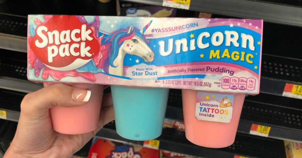 Woman holding Snack Pack Unicorn Magic in Walmart store