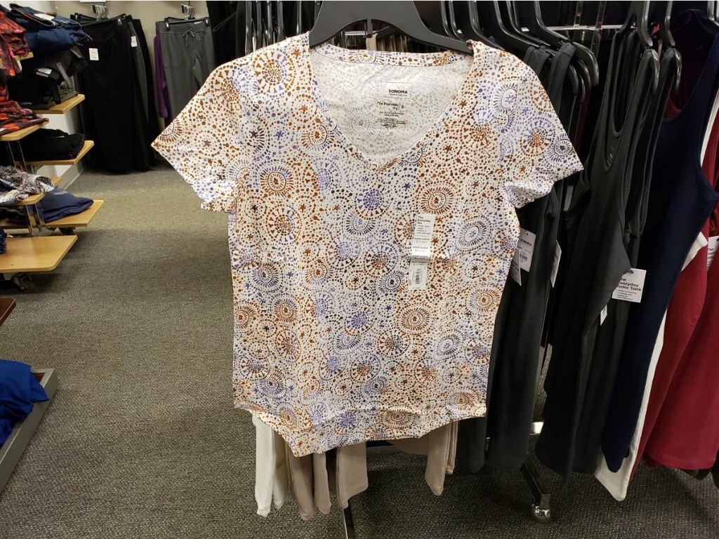 Sonoma woman's tee with circle designs in orange and purple hanging on Kohl's rack