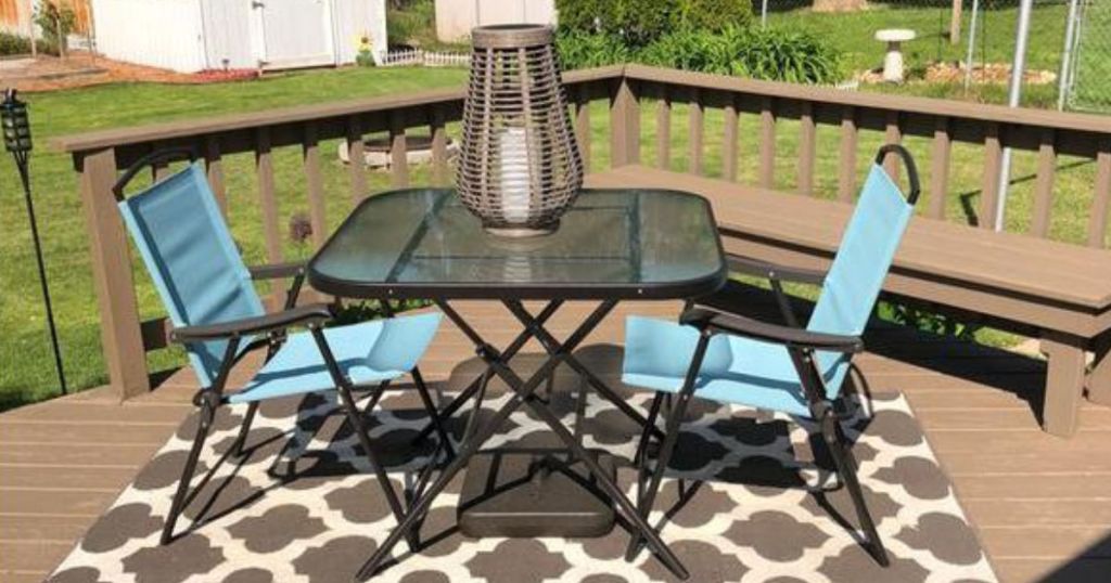 turquoise table set on deck with rug