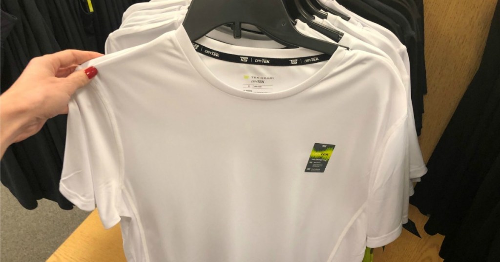 White active wear shirt hanging on hanger in store