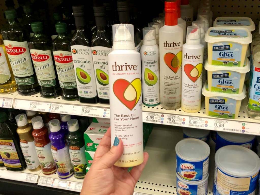 hand holding up thrive cooking oil in store