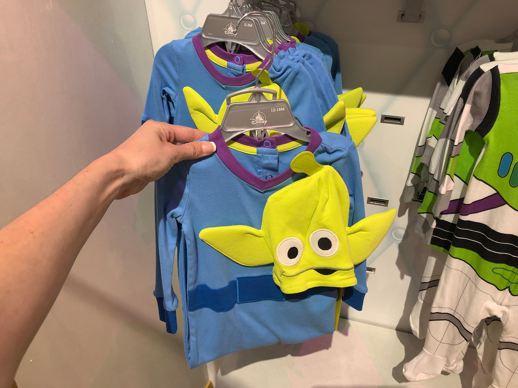 Toy Story 4 Alien PJs being held by a woman's hand at shopDisney 