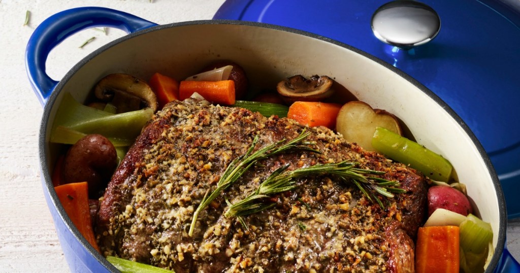 oval-shaped blue cast iron skillet with pot roast dish