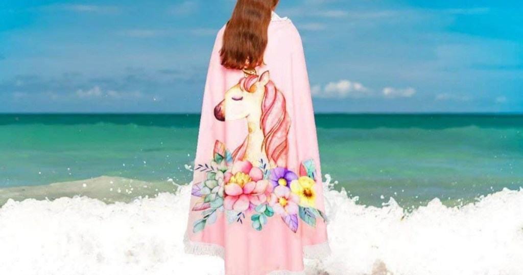 woman wearing Unicorn round beach towel at the beach