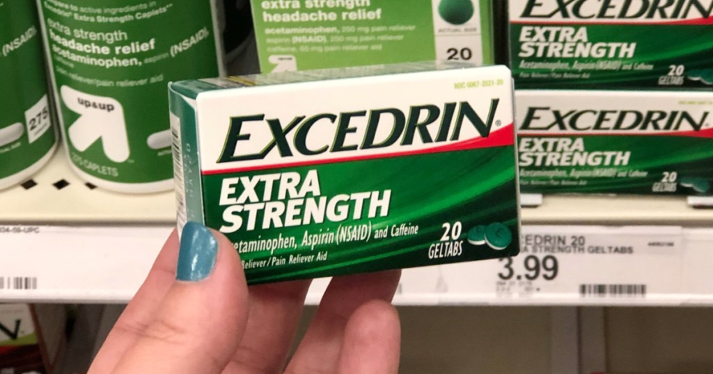 A woman's hand holding Excedrin Extra Strength