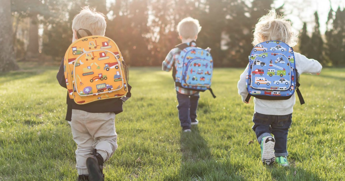 Toddler boys running in field wearing Wildkins Backpacks