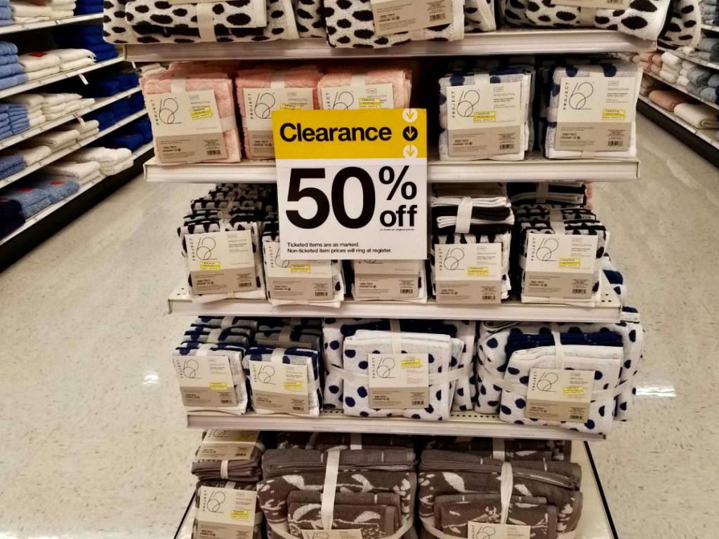 store shelf with 50% off sign for washclothes and towels