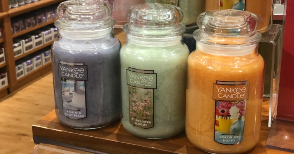 three Yankee Candle Large Classic Jar Candles on a shelf in the store