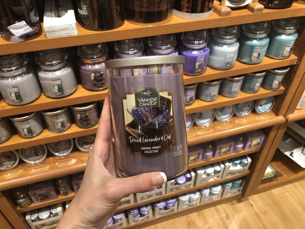 candle being held in front of other candles at Yankee Candle store