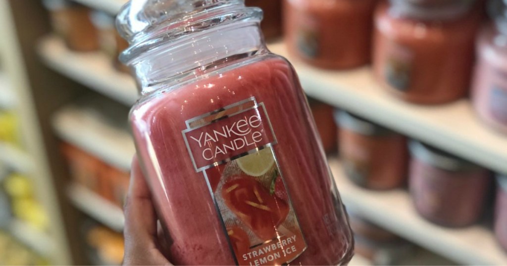 lady holding a red candle in Yankee Candle