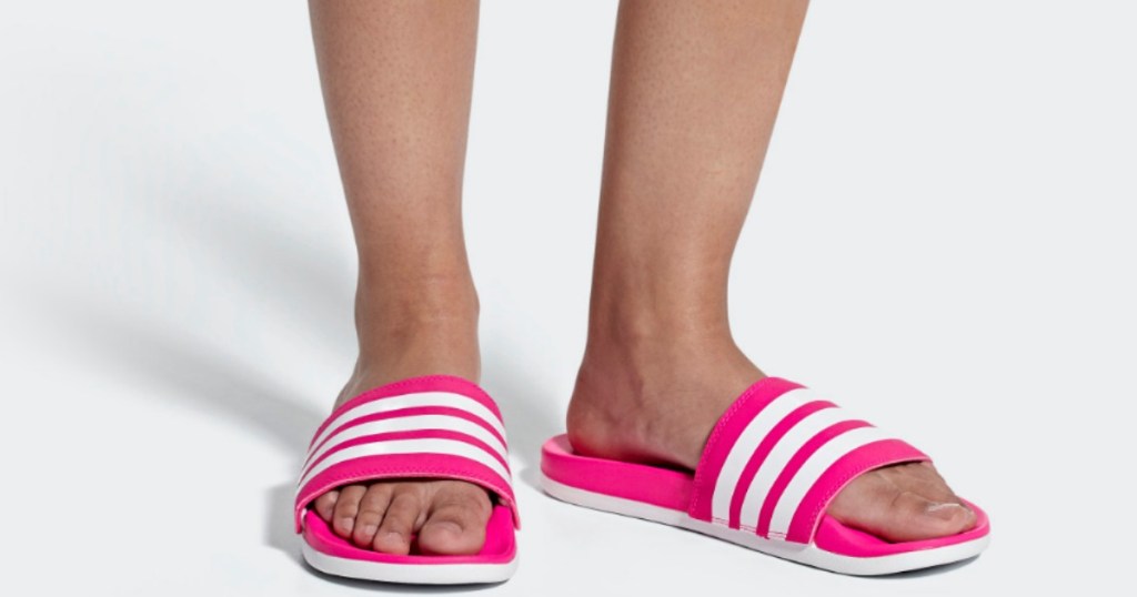 woman's feet in pink and white adidas Adilette Women's Essentials Cloudfoam Plus Stripes Slides