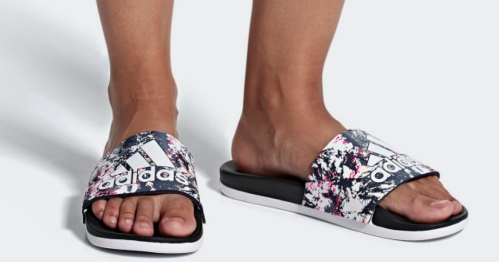 woman's feet in black, white and pink adidas Adilette Women's Swim Comfort Slides