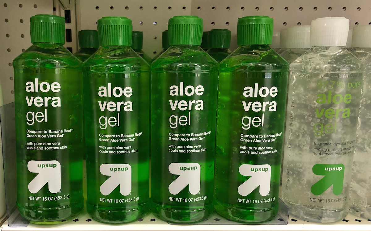 bottles of green and clear aloe vera on store shelf