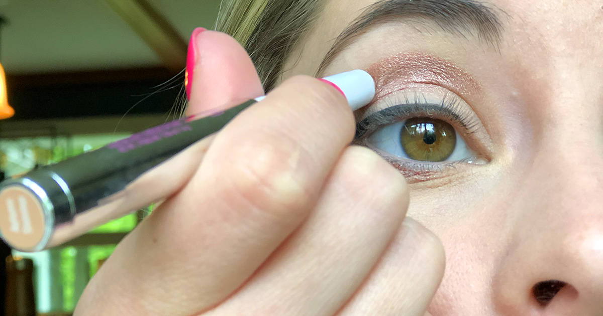 applying mally eyeshadow stick to eyelid