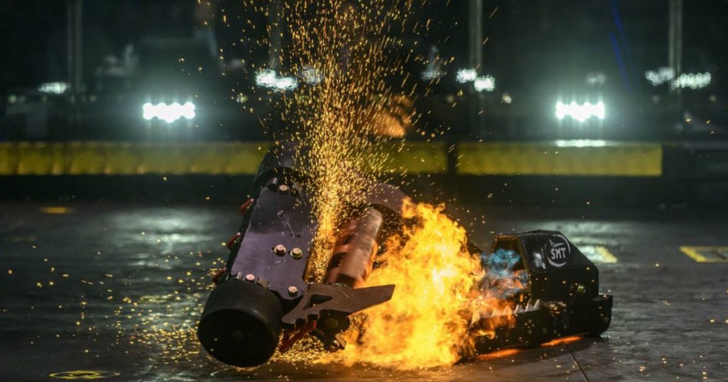 two robots battling with fire and sparks shooting around