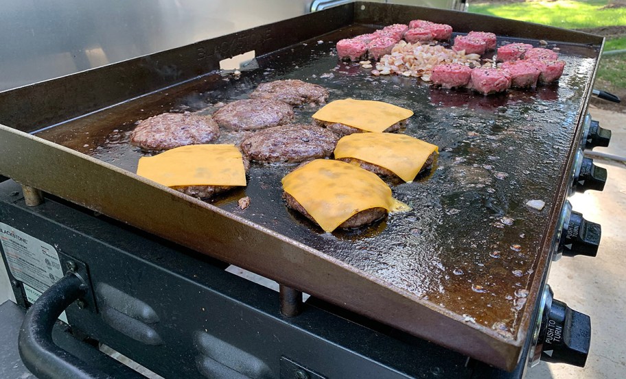 burgers cooking on griddle