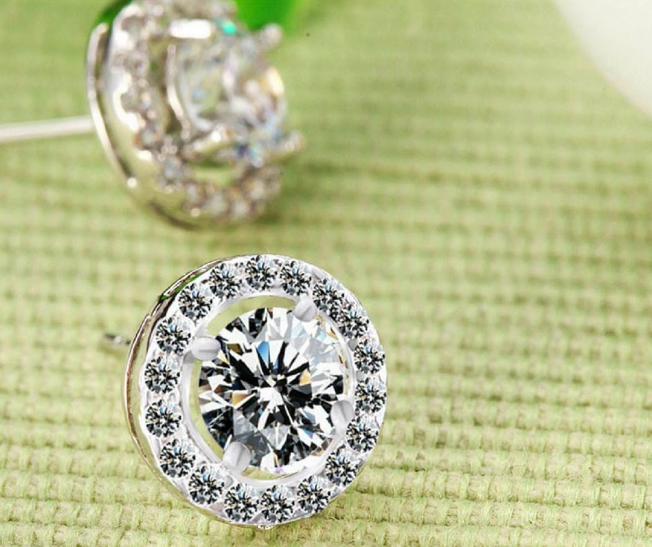 sparkling Cubic Zirconium Earring Studs displayed on green fabric