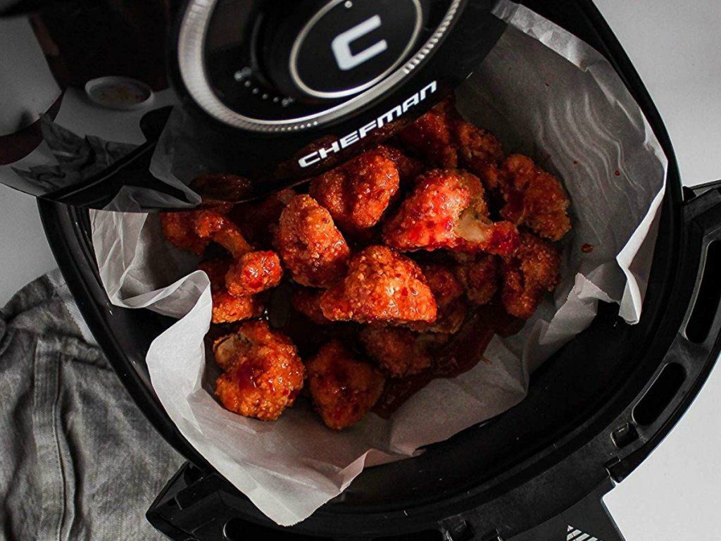 air fryer with chicken wings in its basket