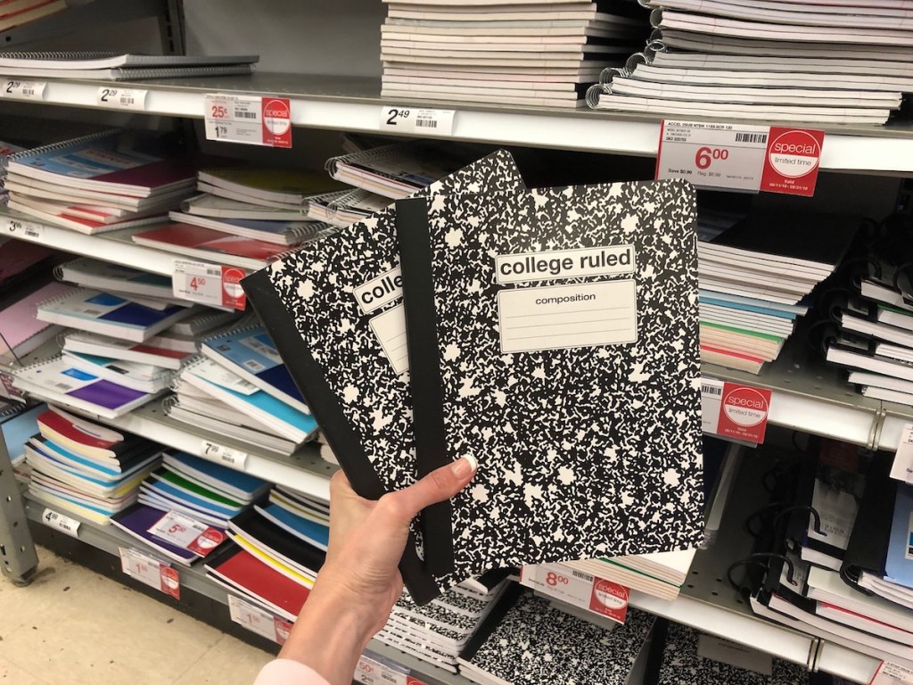 black marble composition books held up in store aisle