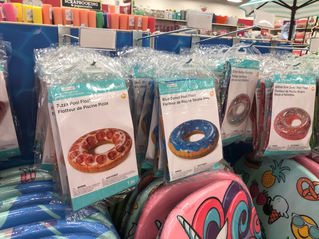 Shelf of pizza, blue donut, and glitter donut creatology drink pool floats at michaels