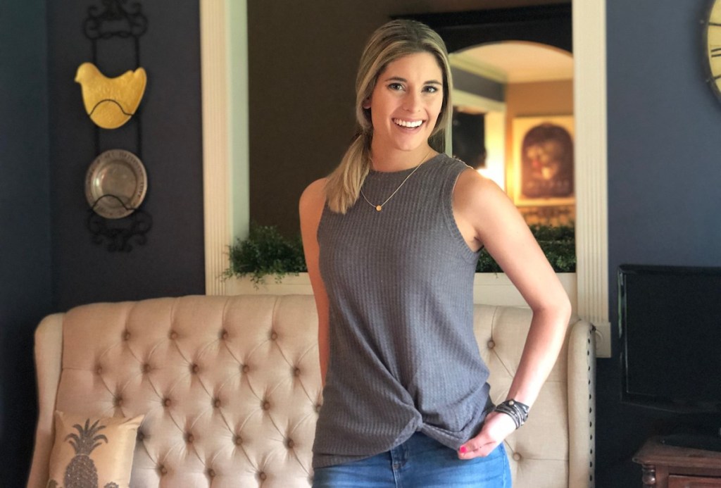 woman wearing gray tank with jeans in living room