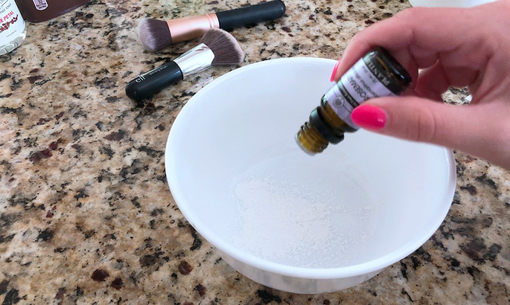 dropping essential oils into dry shampoo powder