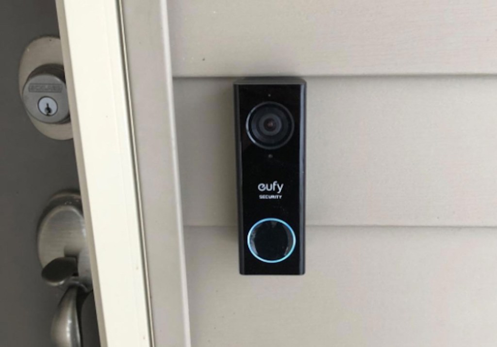 black eufy doorbell on gray house siding