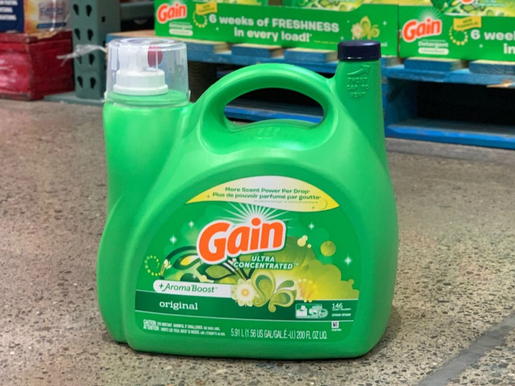 large bottle of gain detergent on ground