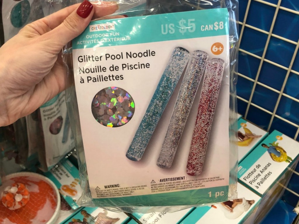 Creatology Glitter pool noodle held in hand at Michaels