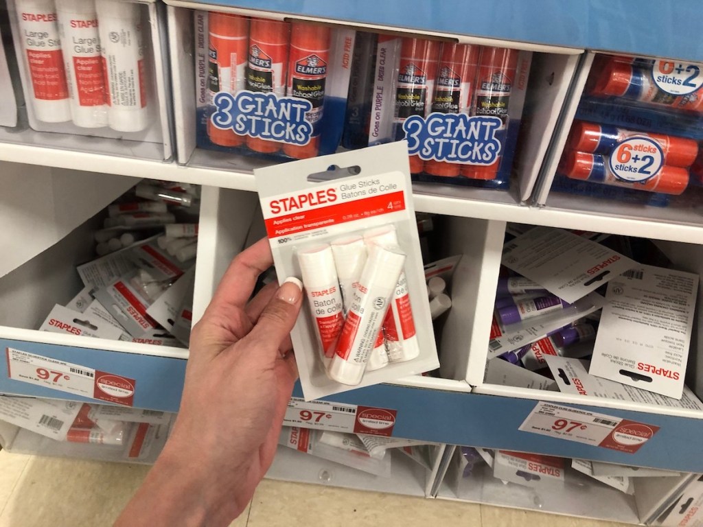 Staples glue sticks 4 pack in package held up in store aisle
