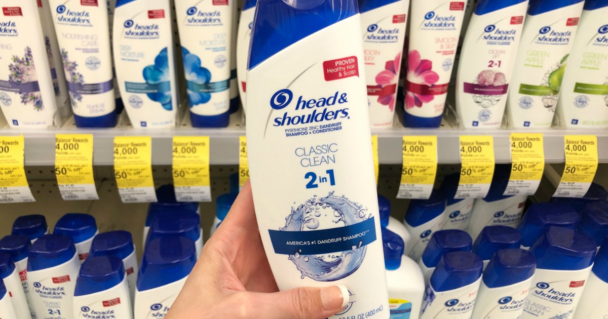 Woman's hand holding Head & Shoulders hair care at Walgreens