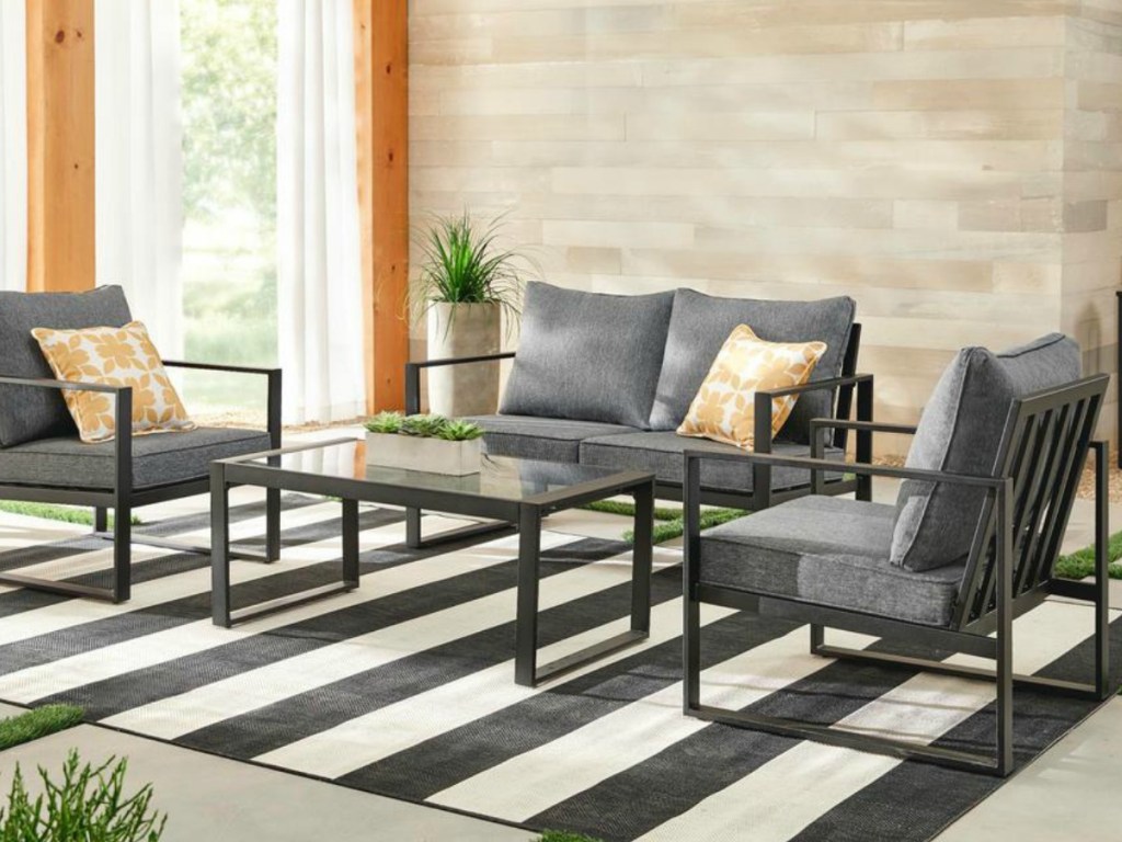 patio set with chairs and loveseat and glass coffee table in sun room
