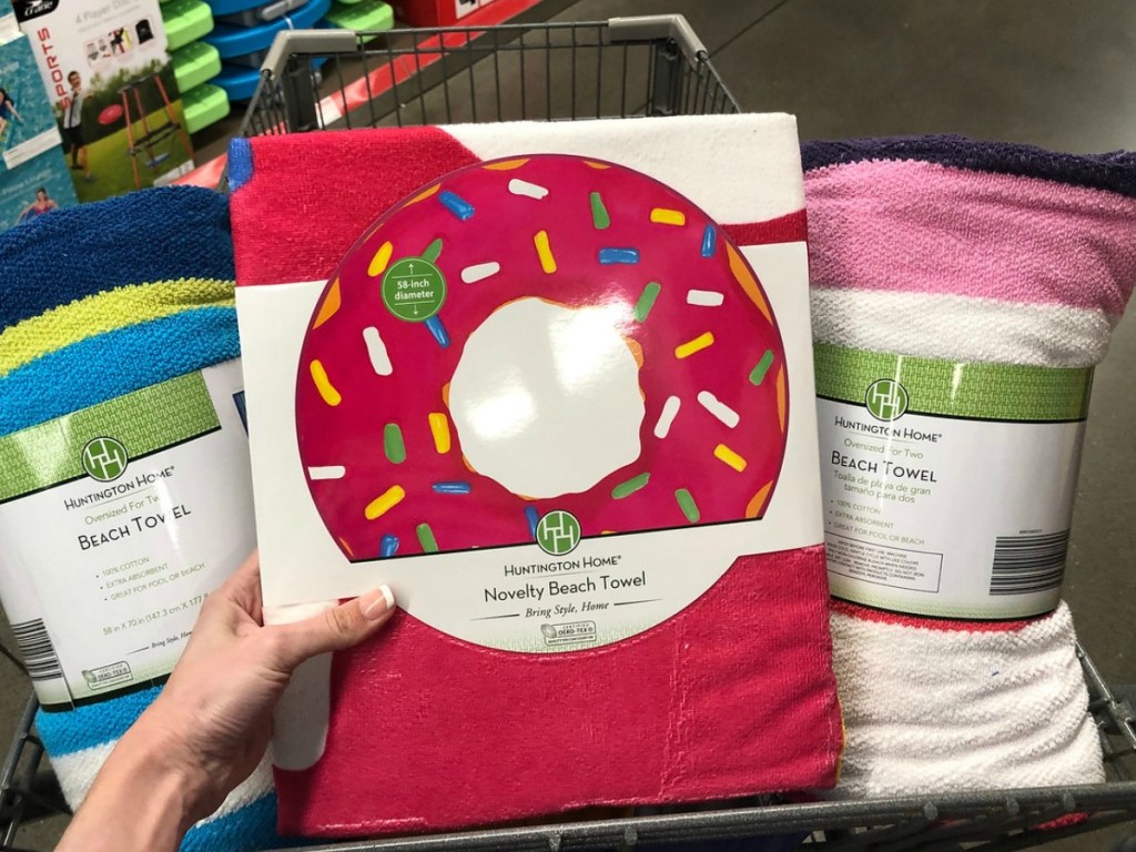 Beach towel in the shape of a doughnut surrounded by more towels