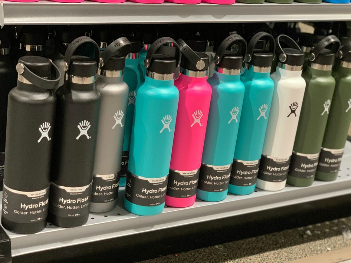 hydro flask bottles in a variety of colors on a shelf in a store