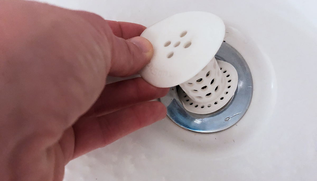 inserting tubshroom device into bath drain