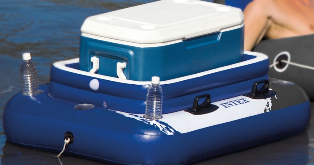 large blue cooler with drinks on a river