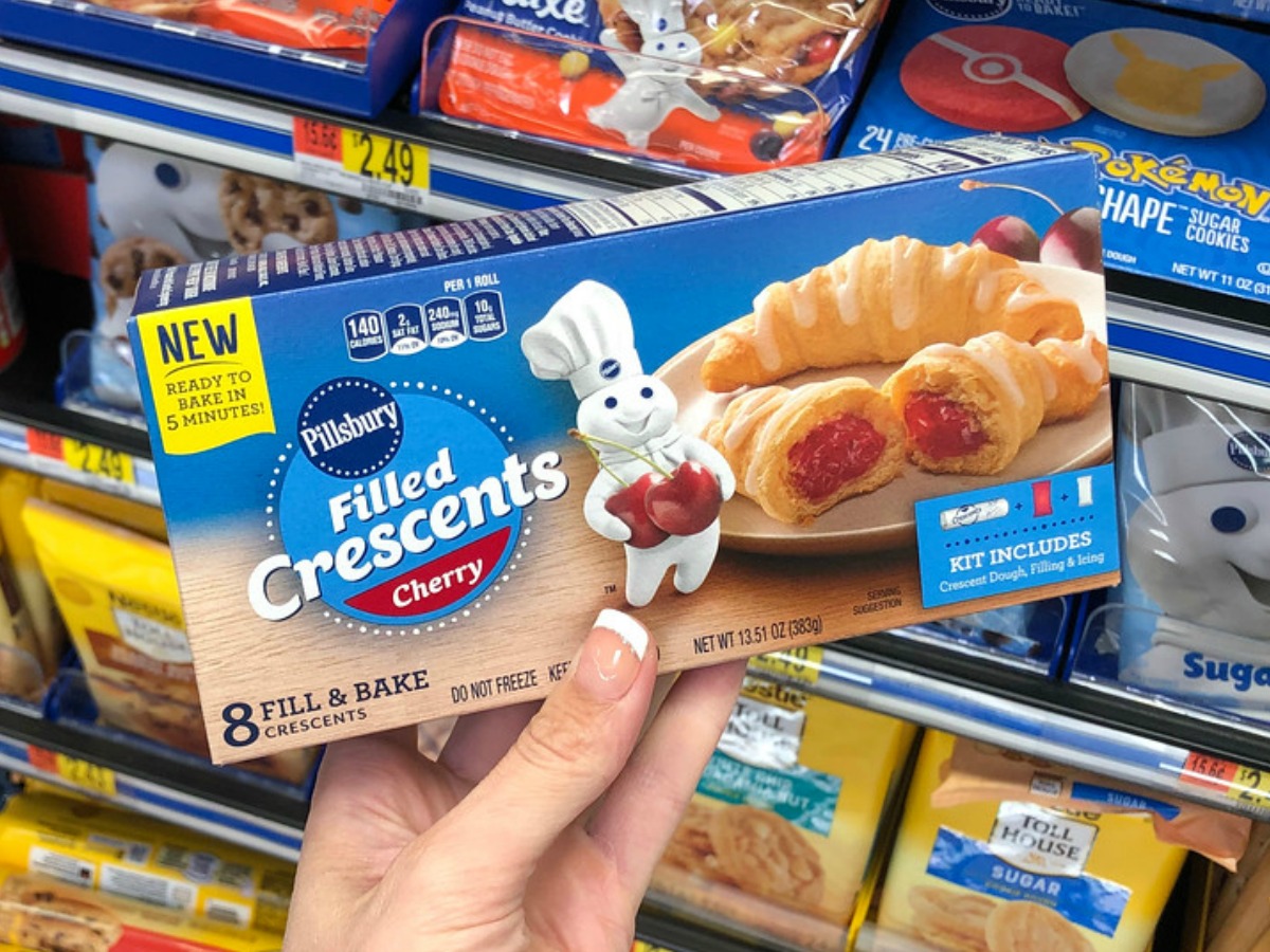 hand holding box of pillsbury filled crescents cherry flavored pastries