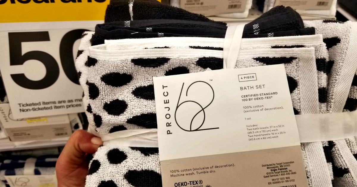 pack of black and white towels in front of clearance sign at store