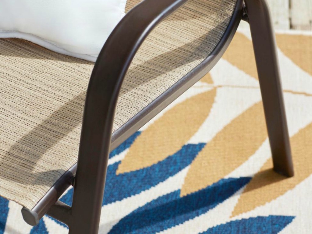 brown side of a chair on colorful rug