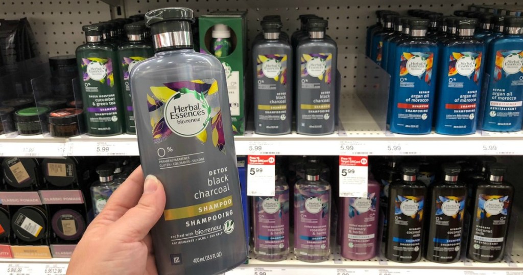 hand holding herbal essences bio:renew shampoo at target