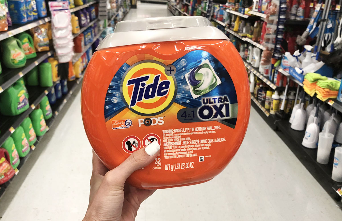 Woman holding a container of Tide PODS
