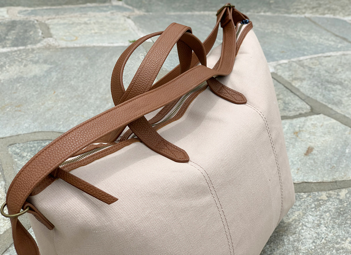 time and tru cream and tan weekender bag zoomed in on handles and zipper