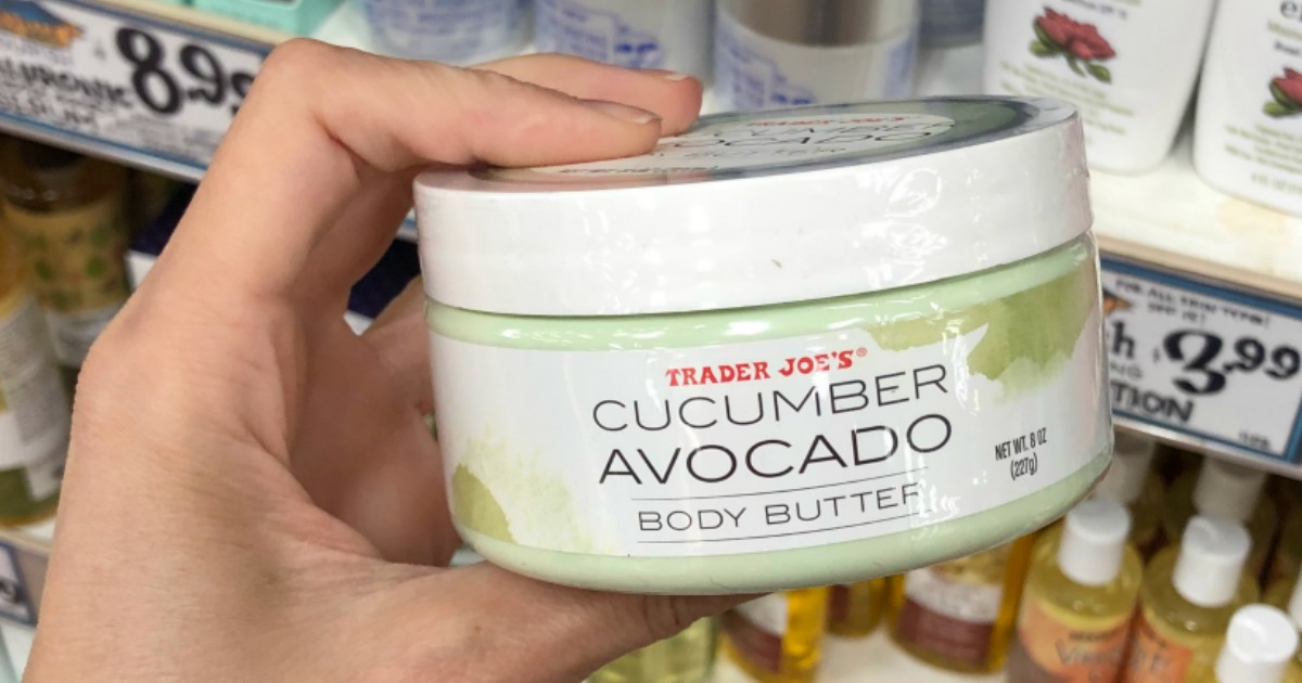 trader joe's cucumber avocado body butter jar being held in store